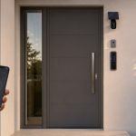 Porta de entrada moderna com fechadura eletrônica, campainha, câmera com painel solar e controle por smartphone.